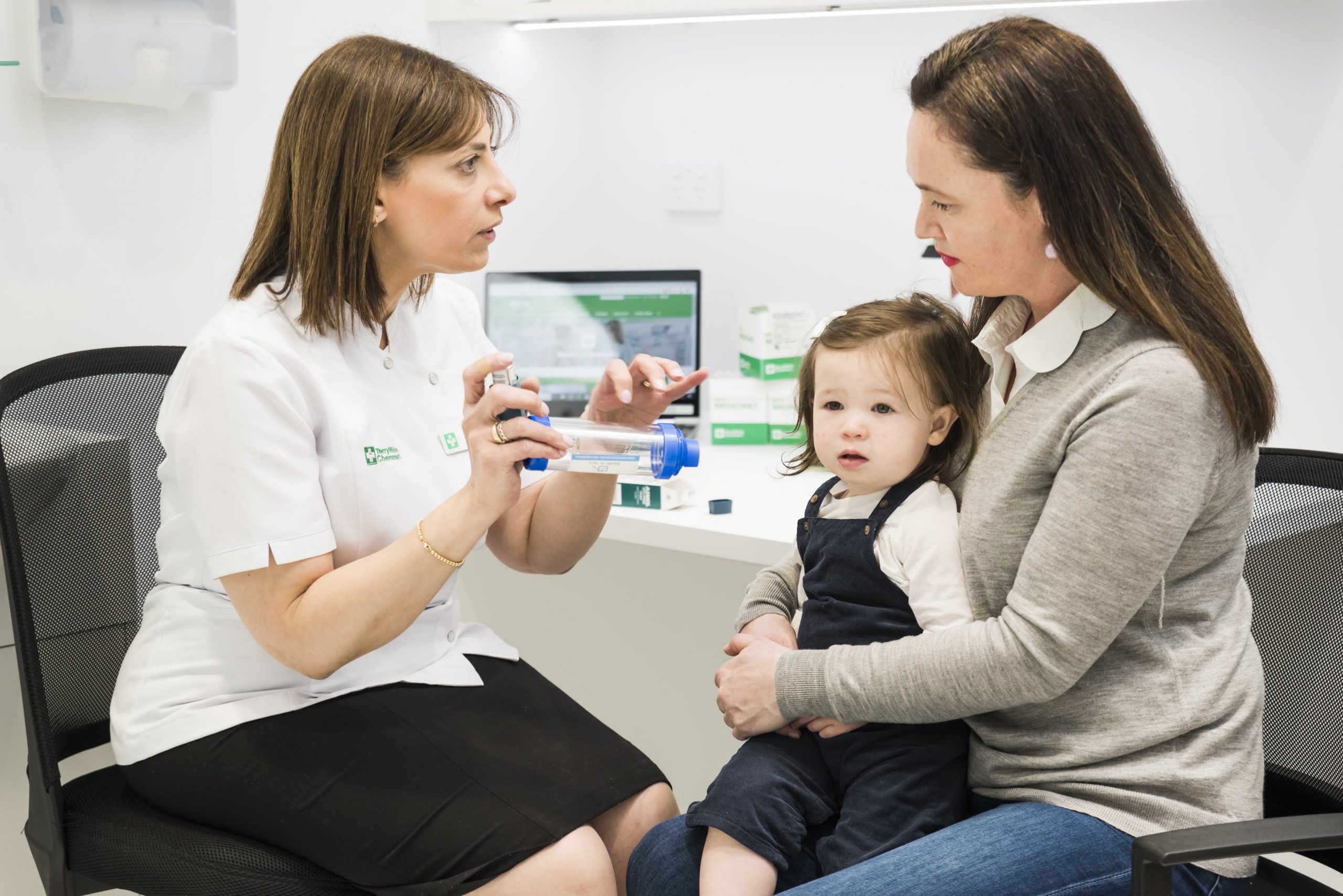 TerryWhite Chemmart pharmacist with a customer and her daughter